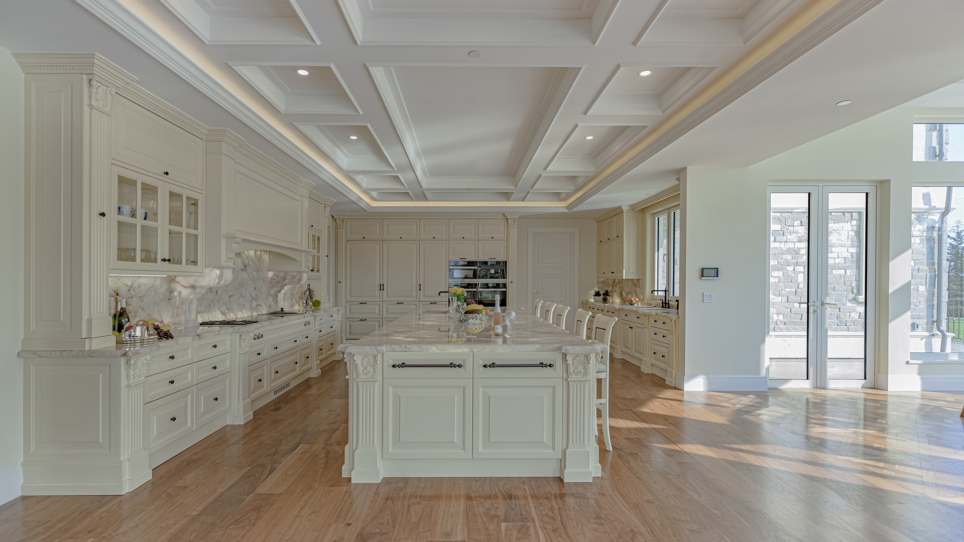 Altamont's Muse gourmet kitchen with coffered ceiling and marble island in West Vancouver