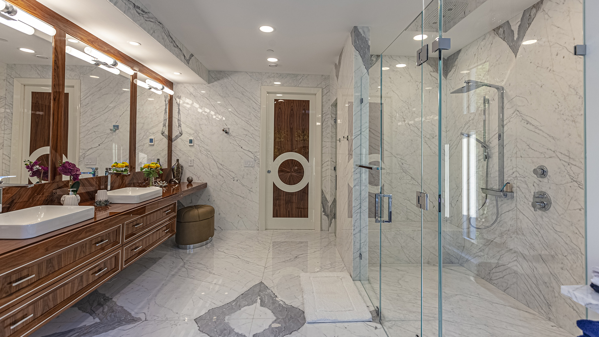 Altamont's Muse primary bathroom walk-in shower with marble walls in West Vancouver