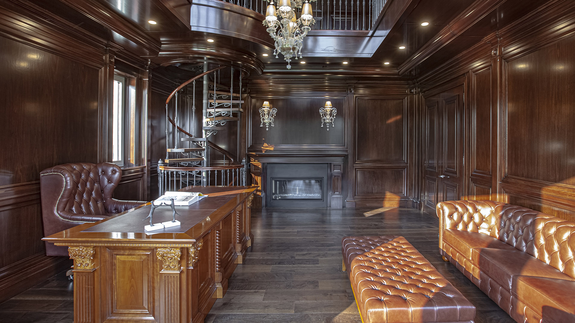 Altamont's Muse study view toward fireplace with cognac leather furniture in West Vancouver