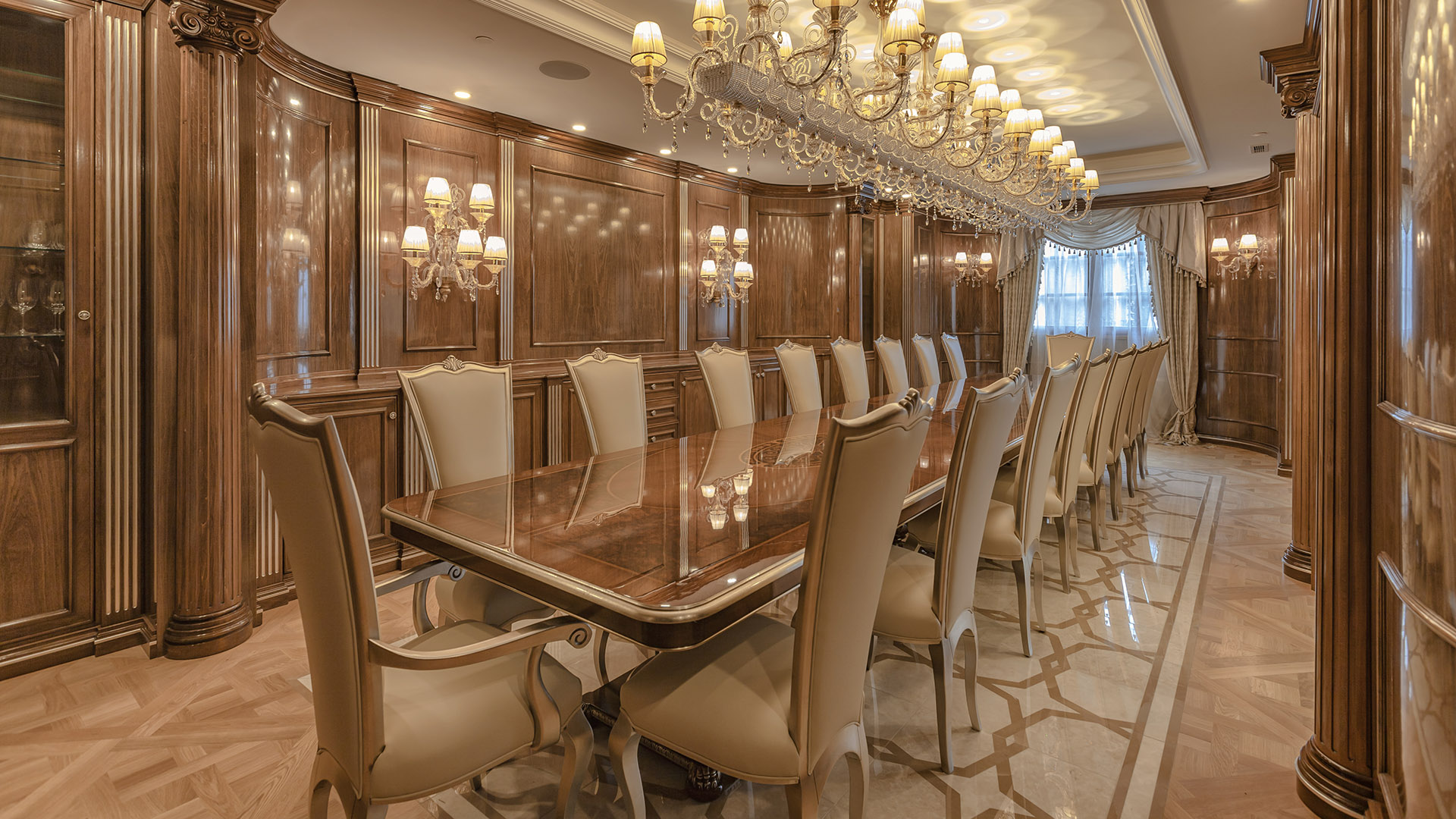 Ambleside Palace 20-seat banquet dining room with walnut columns and crystal chandelier in West Vancouver