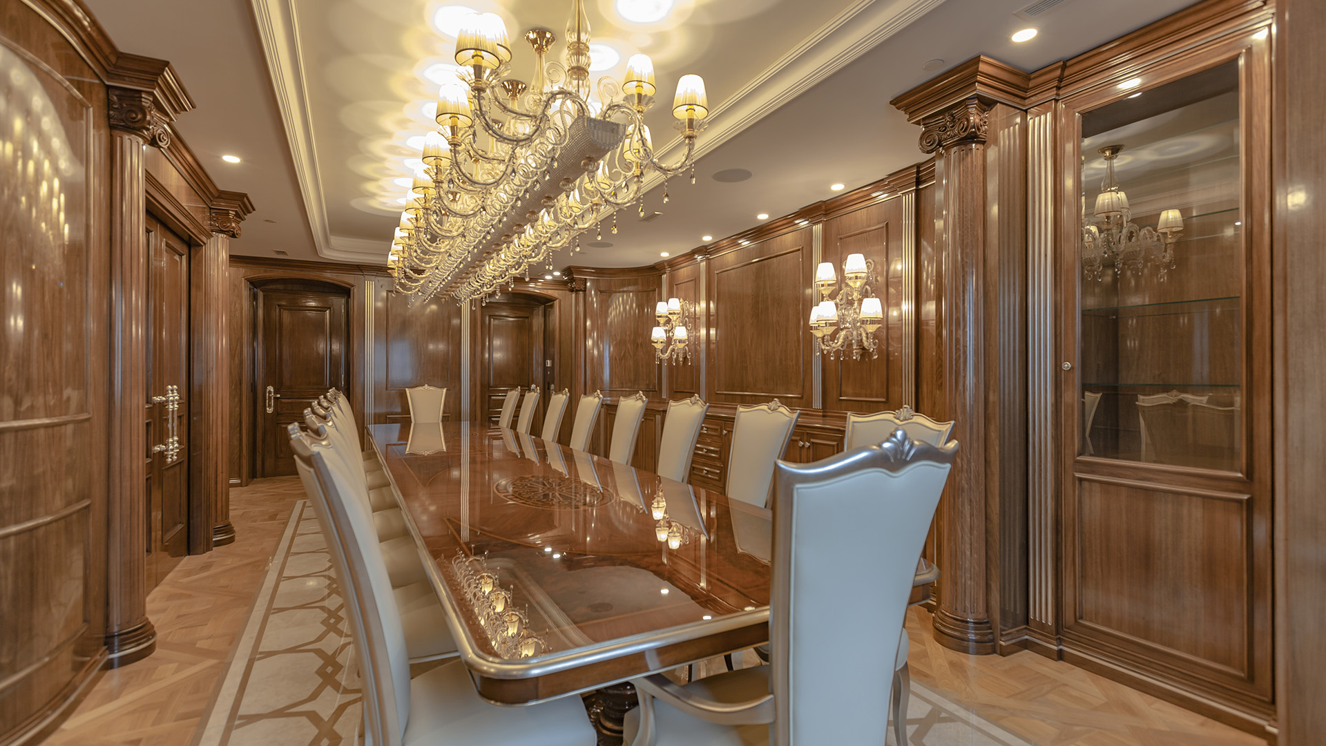 Ambleside Palace dining room with glass display cabinets and herringbone parquet flooring in West Vancouver