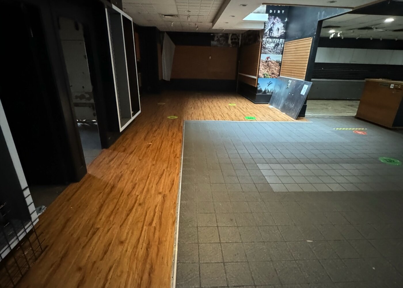 Interior view of retail space showing damaged flooring requiring full replacement after water damage