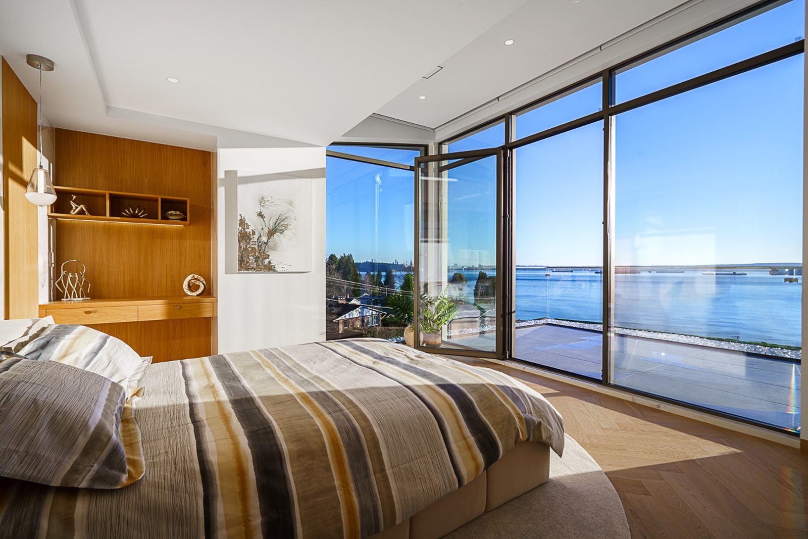 Secondary bedroom with corner ocean views and built-in walnut shelving luxury Altamont West Vancouver home