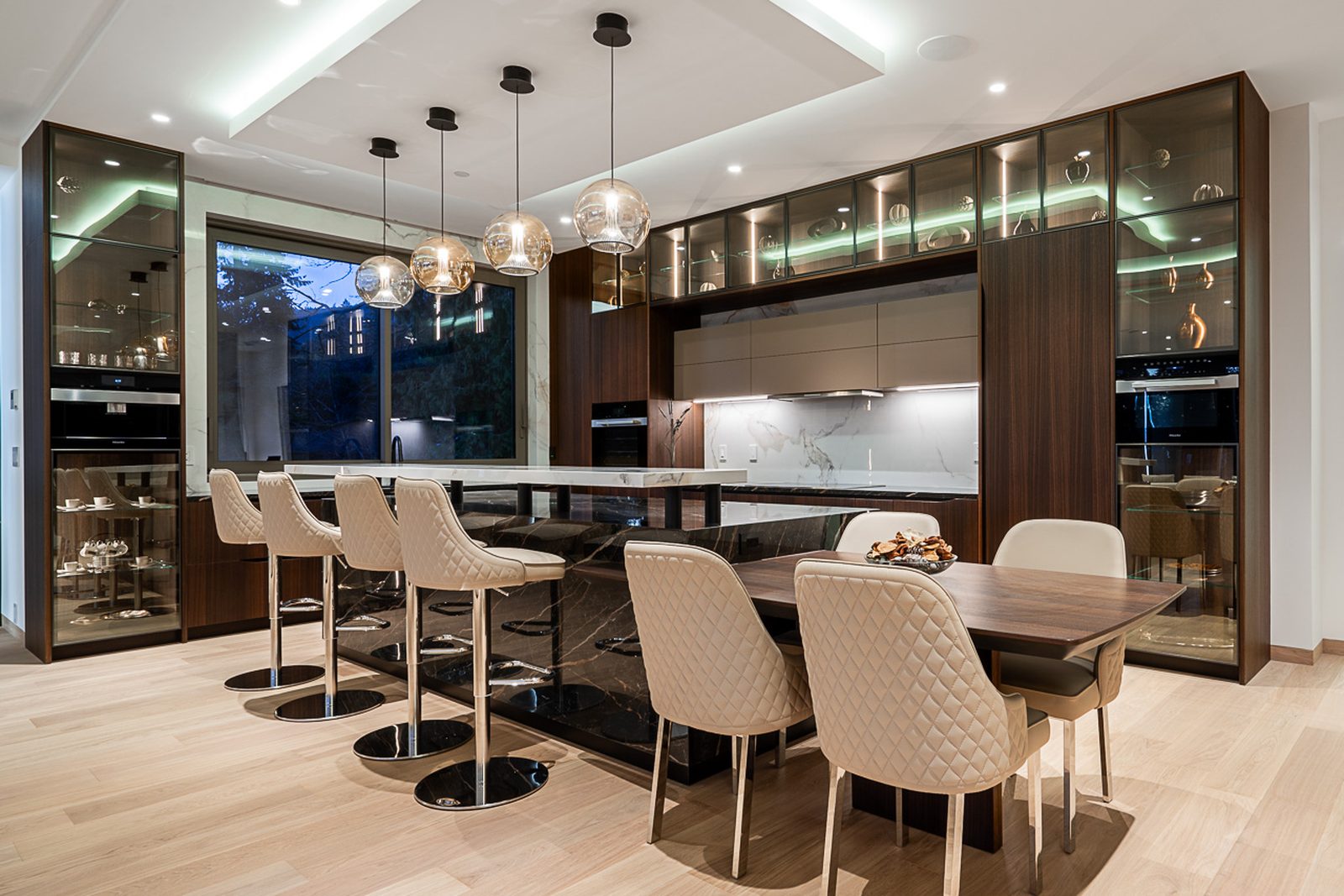 Open-plan main floor showing kitchen dining and living areas with oak floors at The Butterfly Altamont