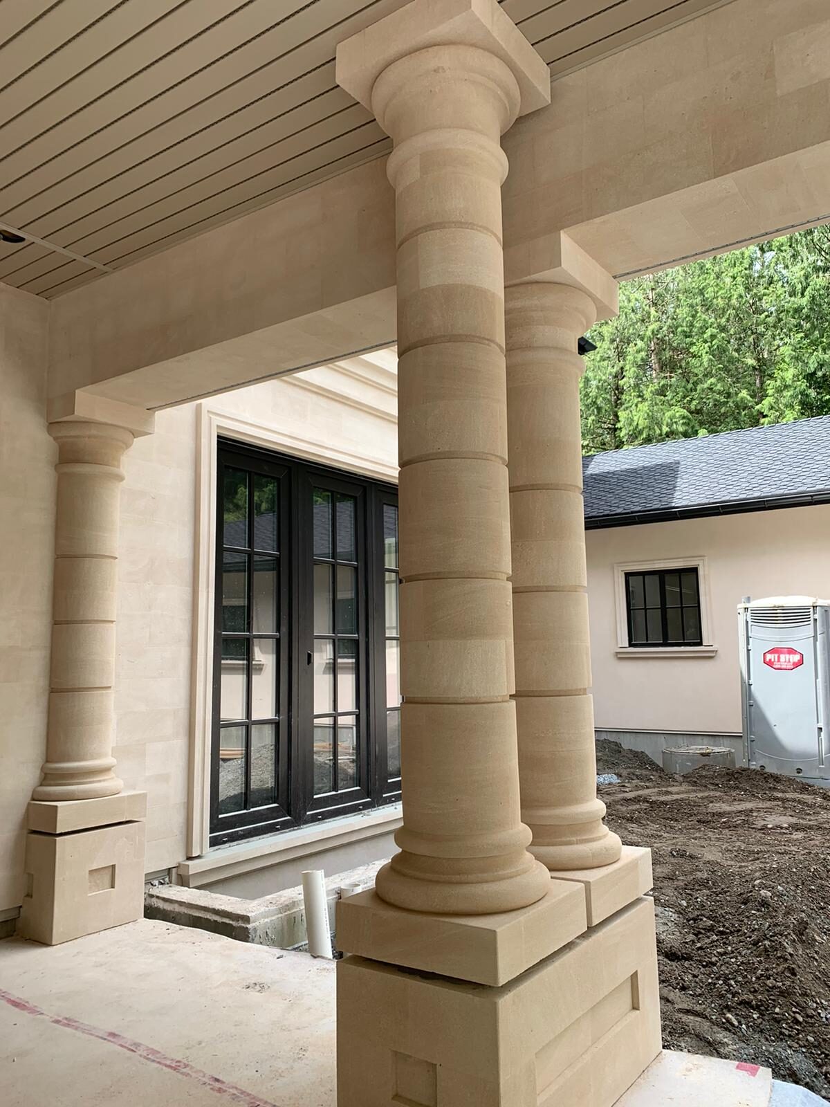 Sandstone column and mullion detail with garage wing
