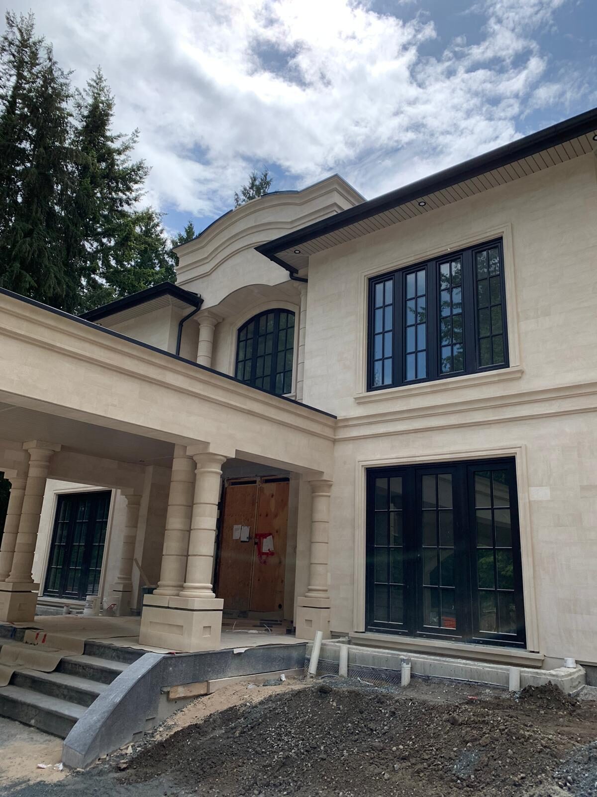 Upper floor arched windows and carved pediment