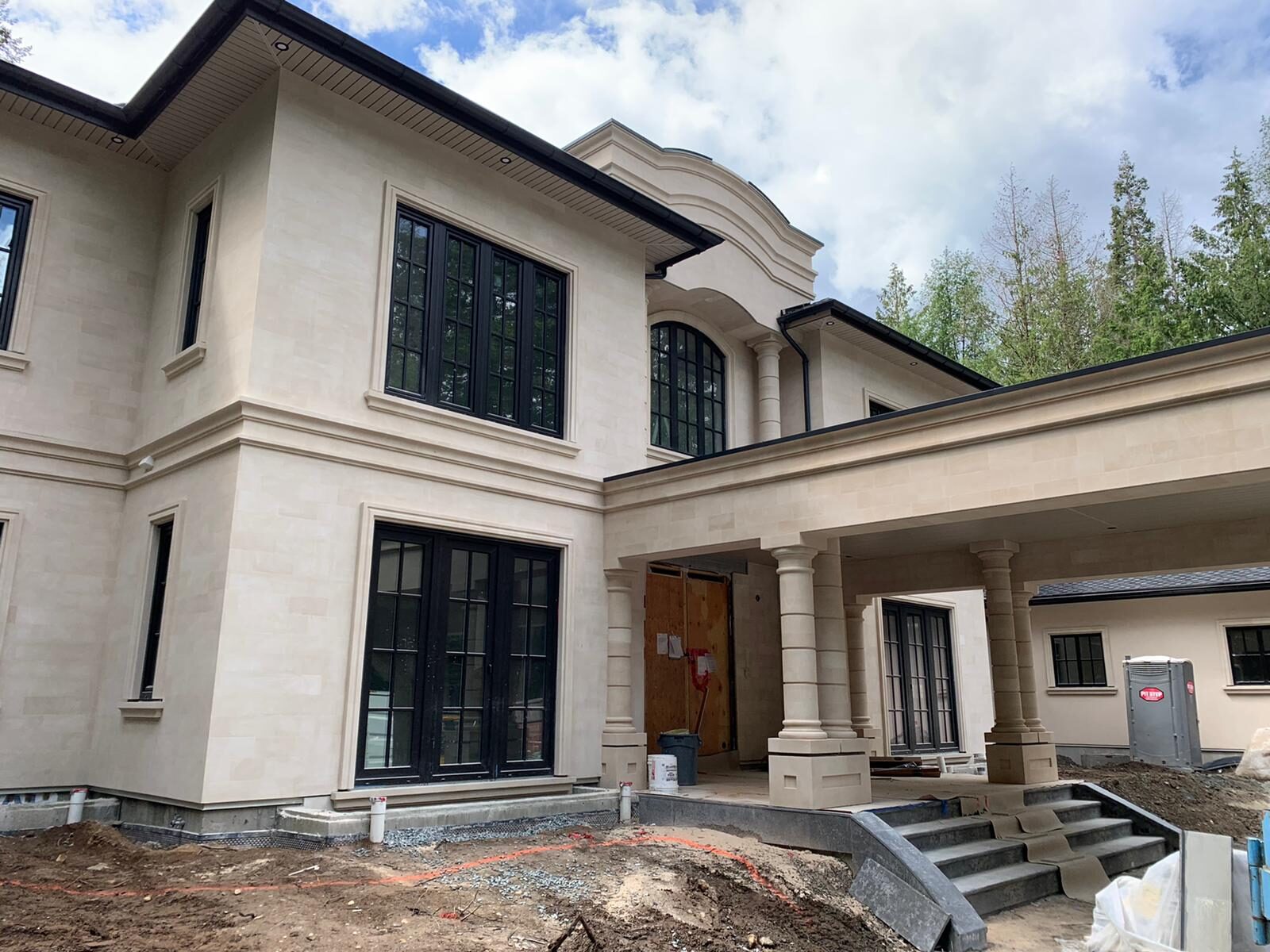 Front entry with sandstone cladding and classical columns