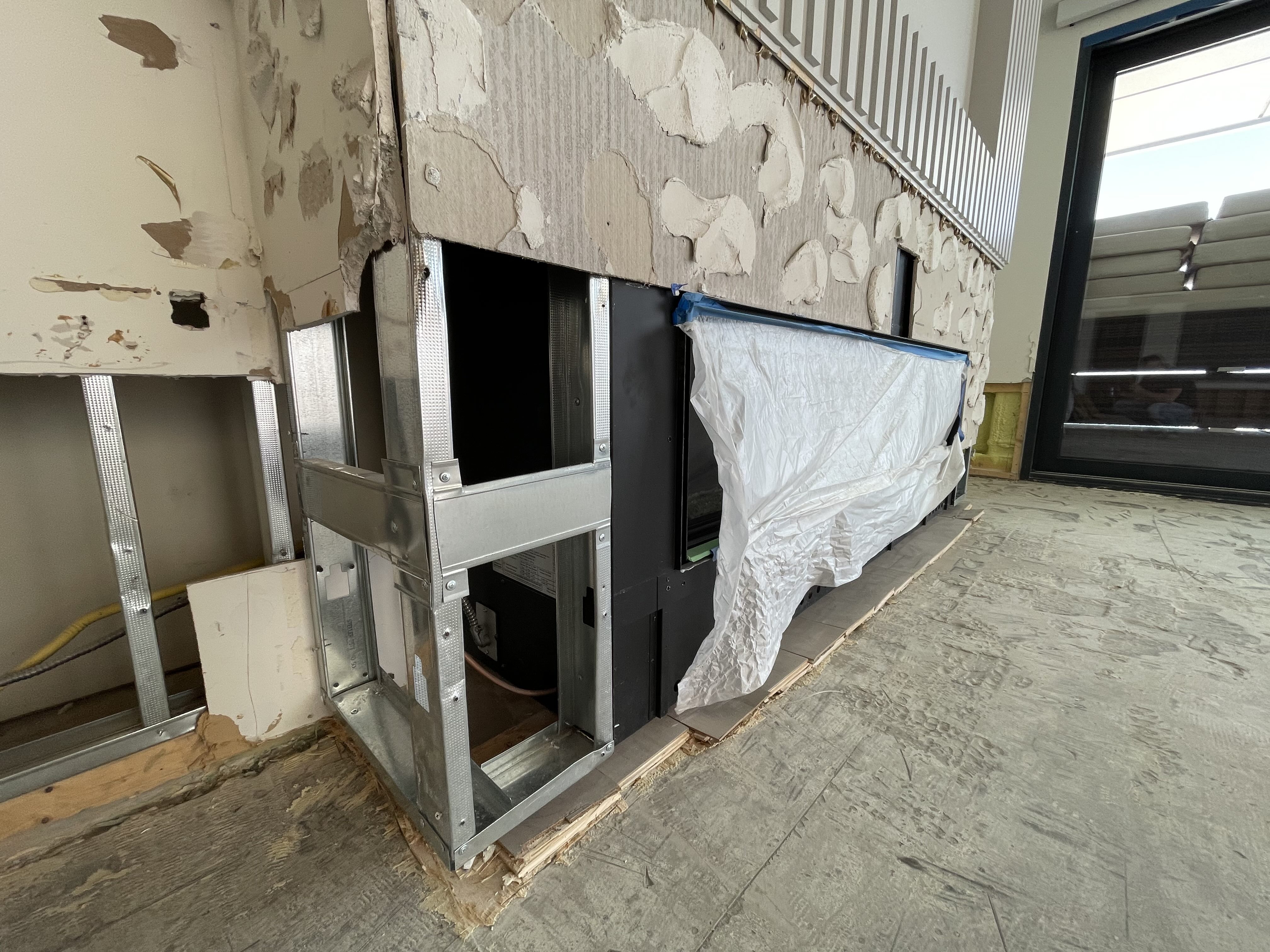 Interior stripped to structural elements after water damage — reconstruction in progress