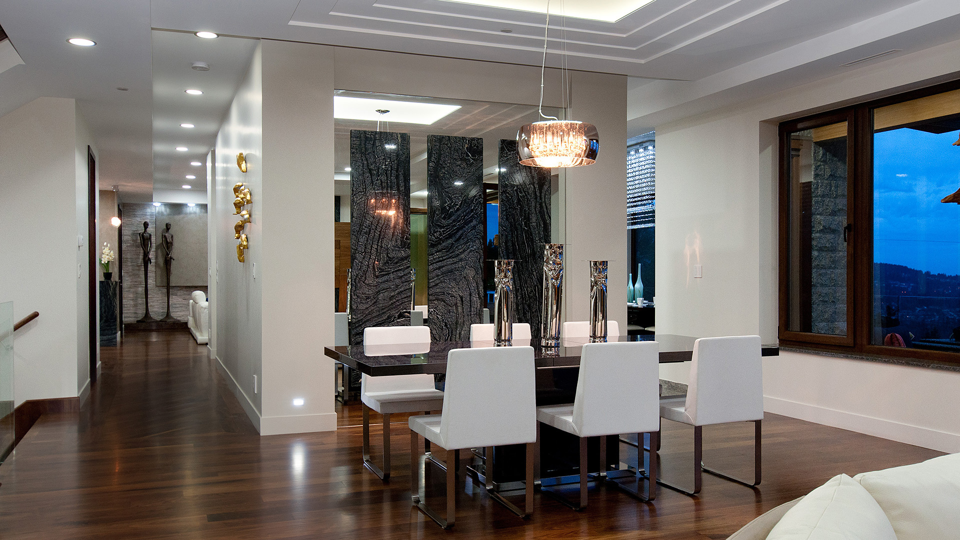 Formal dining area with full-height black marble feature panels walnut flooring chrome pendant light and city views Millstream British Properties West Vancouver