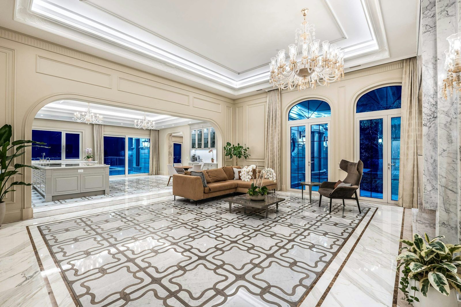 Grand living room with ornate marble mosaic floor and crystal chandelier at Montbeau Eyremount West Vancouver