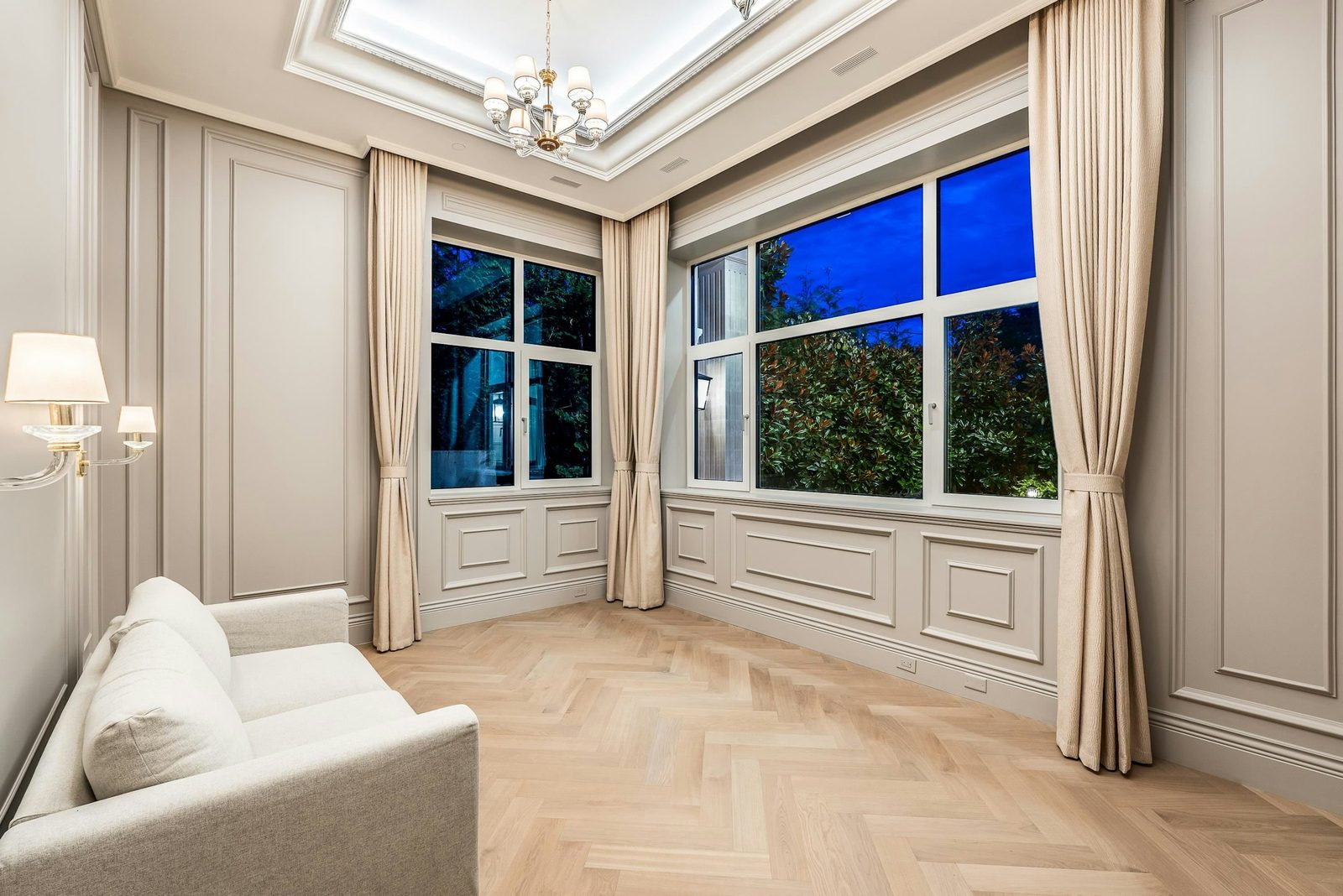Sitting room with herringbone oak floors and wainscoting panels at Montbeau Eyremount West Vancouver