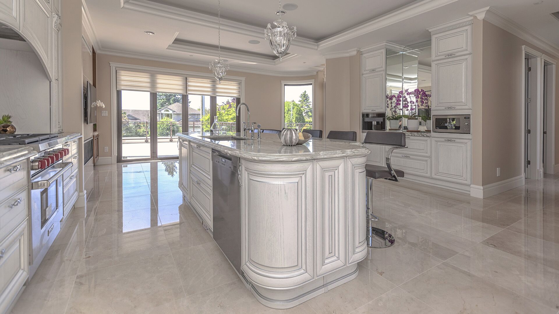 Italian classical kitchen island with curved solid wood panelling, marble countertop, professional appliances, and built-in coffee station designed and installed by Eurohouse Construction in West Vancouver