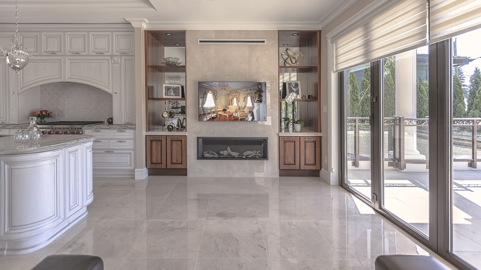 Custom walnut entertainment centre with linear gas fireplace, stone surround, and Italian classical kitchen in background — designed and installed by Eurohouse Construction West Vancouver