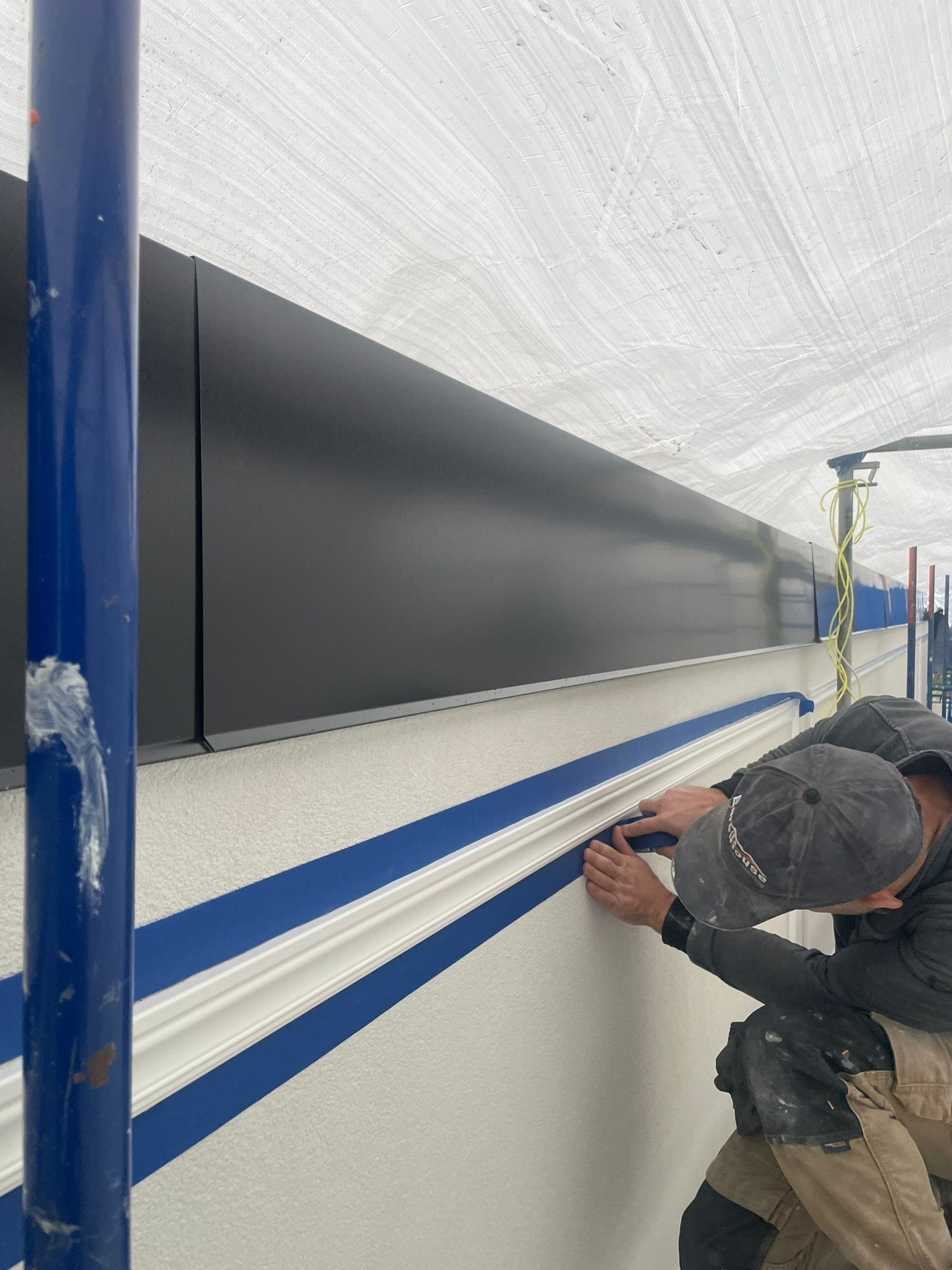 Scaffolding and protective wrap during exterior renovation of Pierwell presentation centre in Dundarave