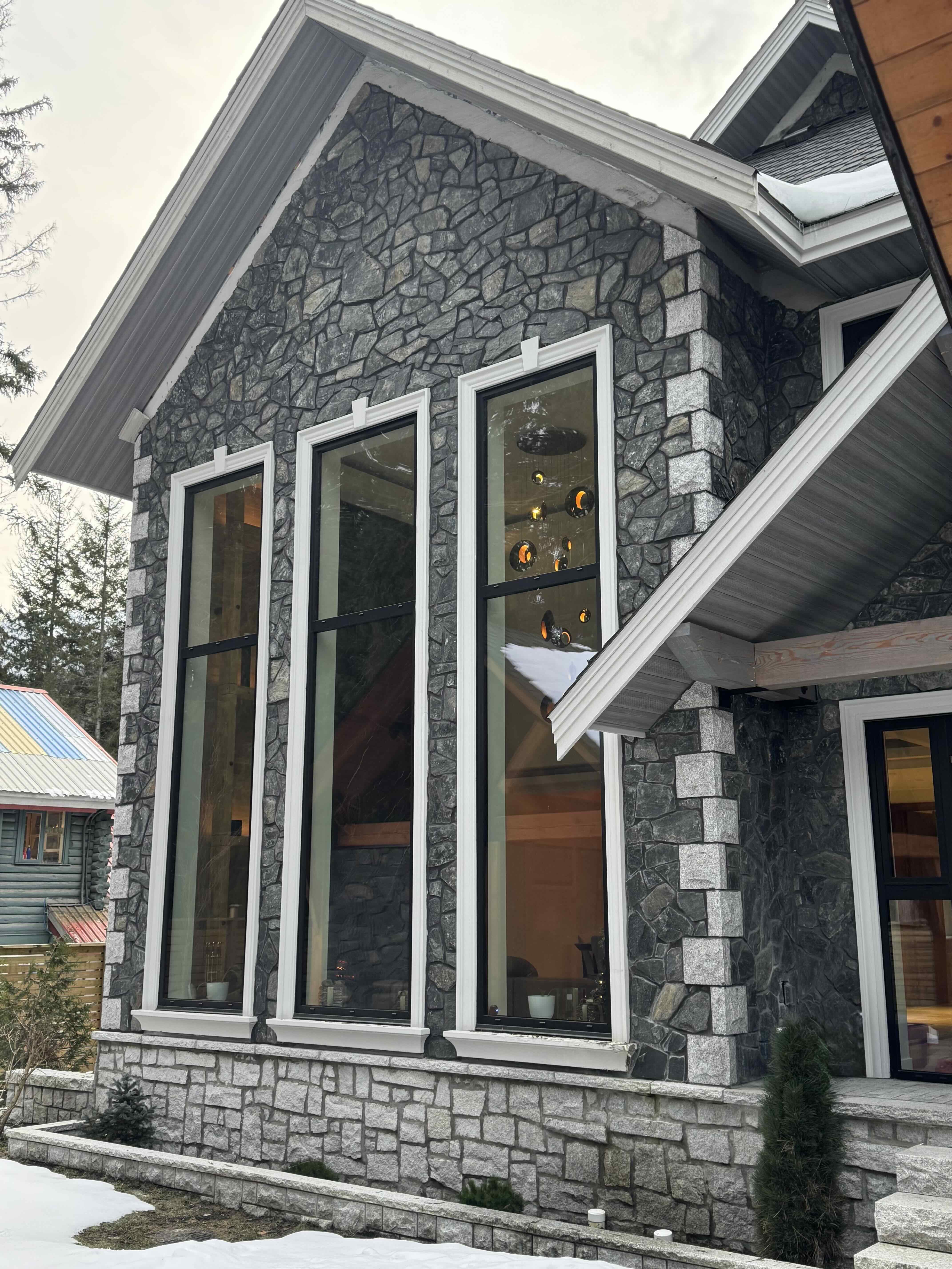 Rear gable with full-height windows and timber post-and-beam gazebo at Rainbow in Whistler luxury home by Eurohouse Construction