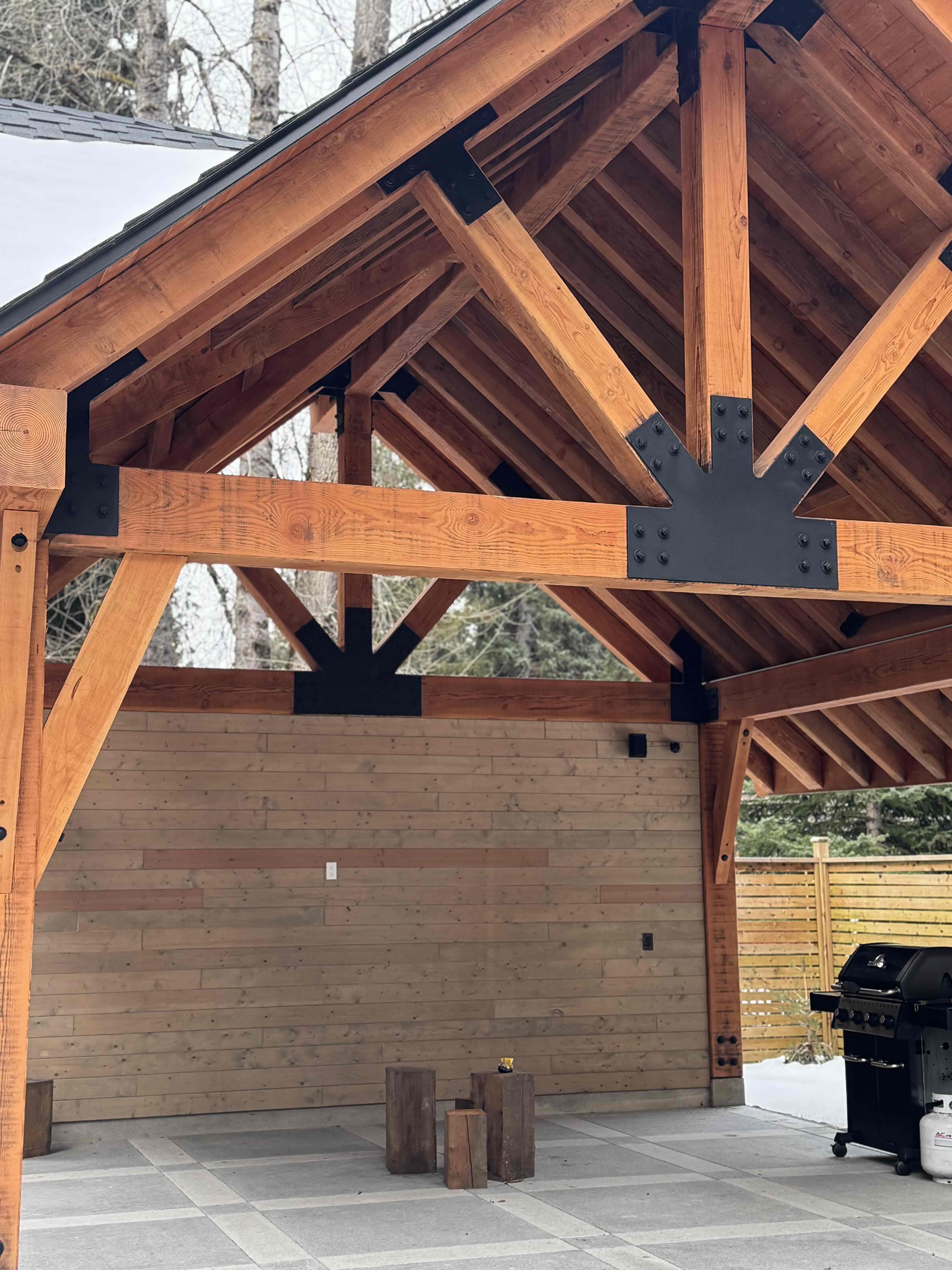 Timber gazebo structural detail showing heavy timber rafters and decorative steel gusset plates at Rainbow in Whistler by Eurohouse Construction