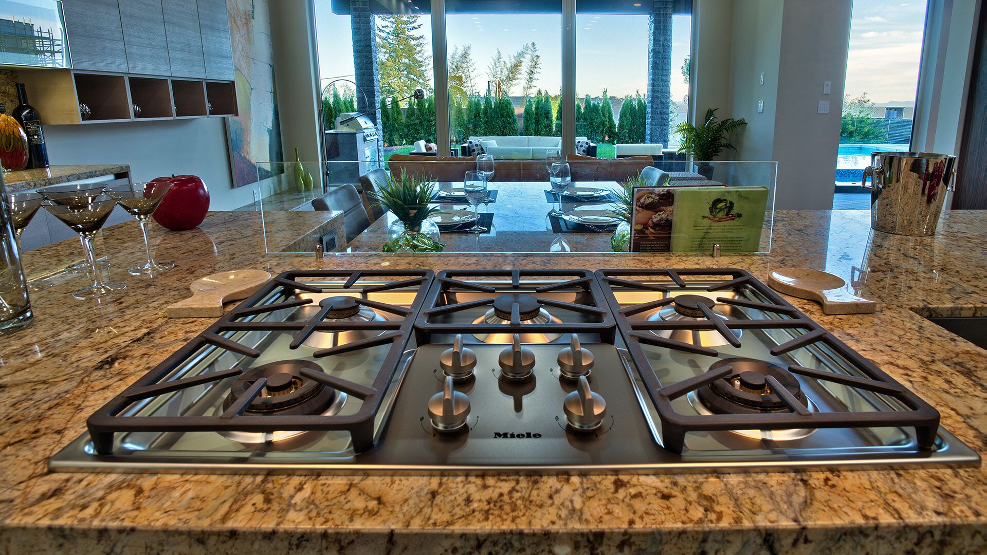 Miele gas cooktop on granite island with ocean views at Rose Crescent Sandy Cove West Vancouver by Eurohouse Construction