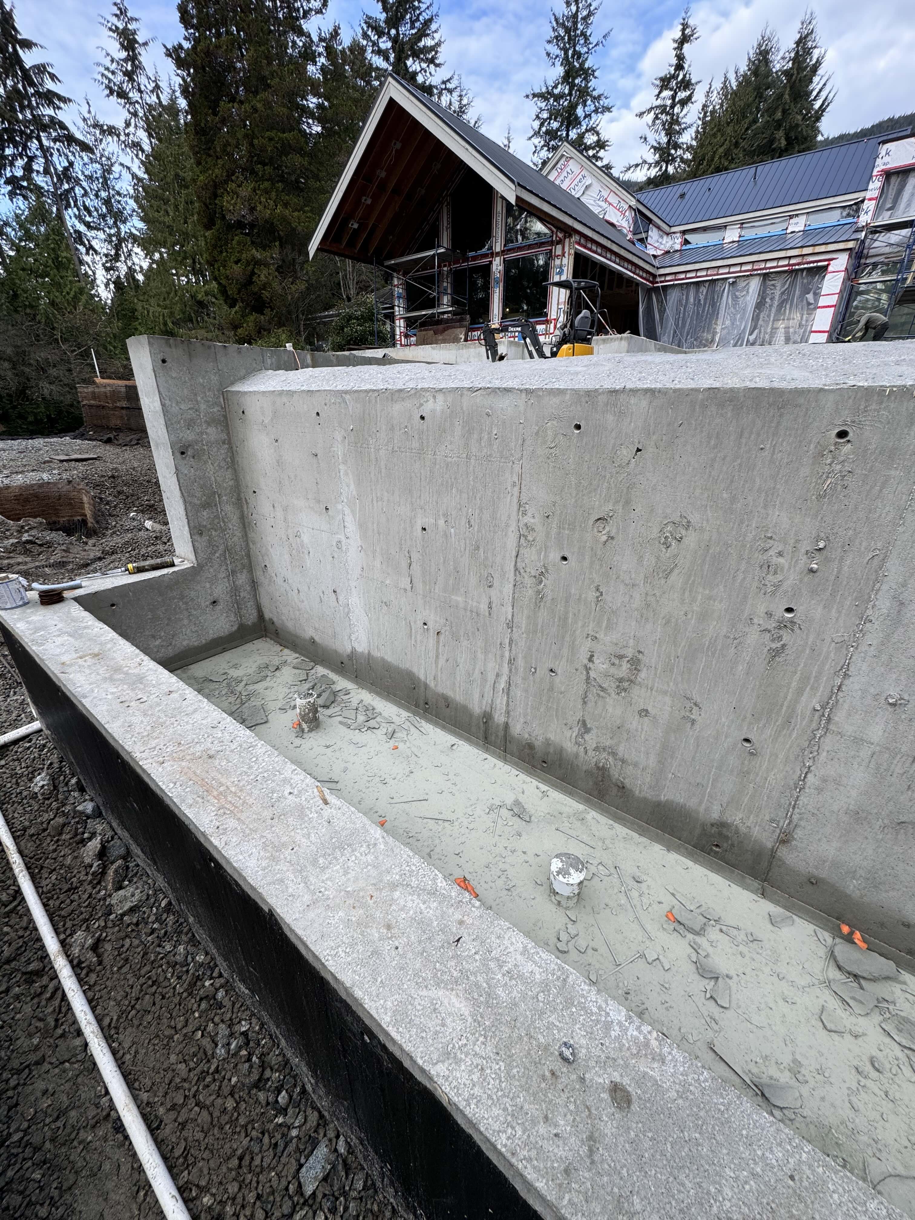 Concrete pool shell and barn house framing under construction on Spencer Road West Vancouver by Eurohouse Construction