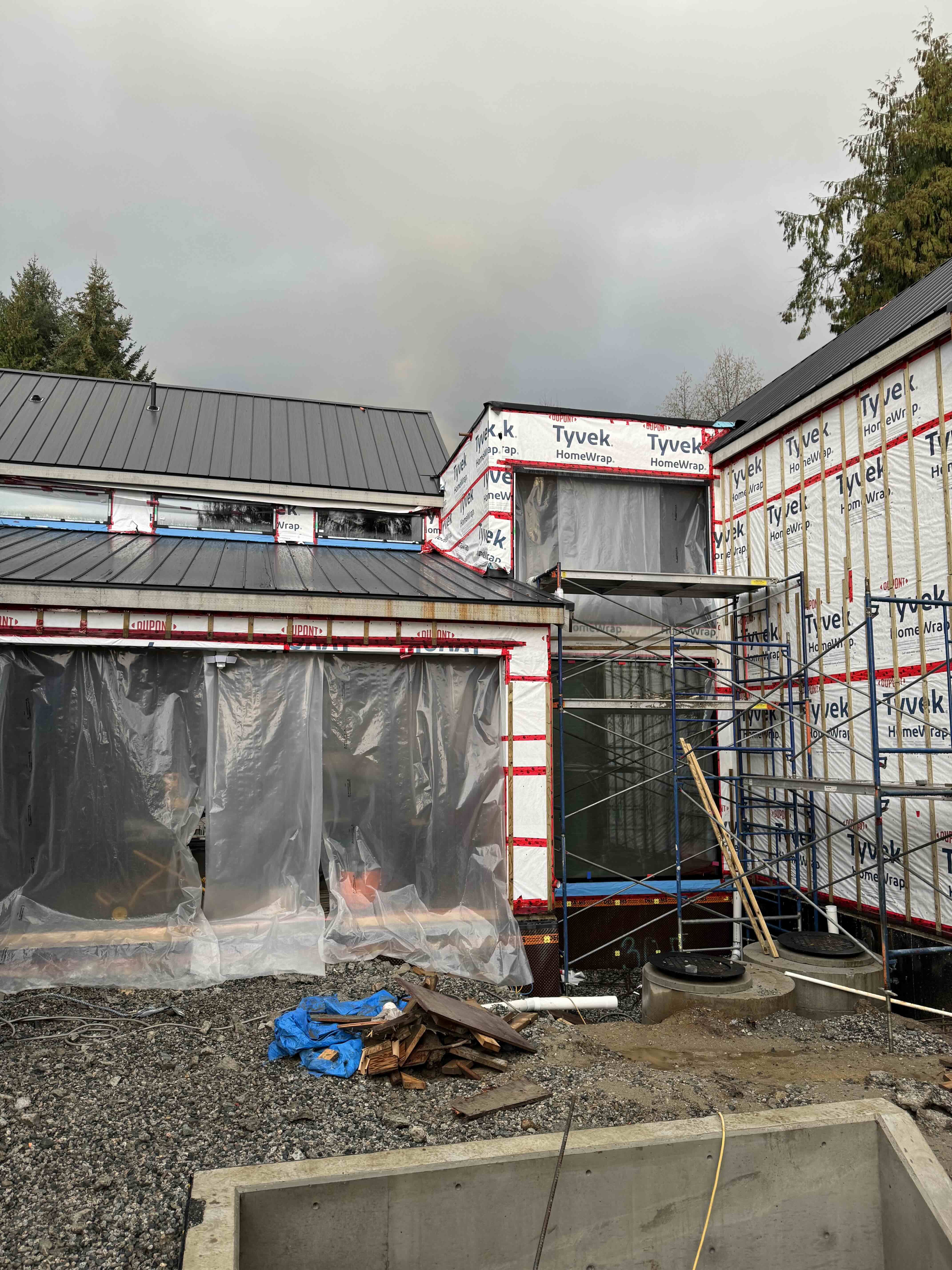 Standing seam metal roof and Tyvek envelope at Scandinavian barn house West Vancouver by Eurohouse Construction