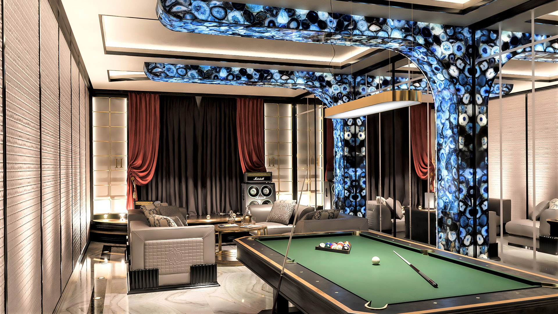 Wide view of entertainment billiards room with illuminated agate stone architecture, professional pool table, Marshall speakers, and red velvet drapery in The H House West Vancouver