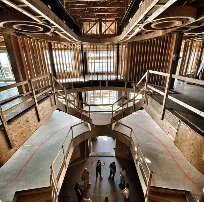 Complex curved wood framing and grand staircase construction in The H House — multi-level atrium with circular ceiling details and sweeping staircase built by Eurohouse Construction West Vancouver