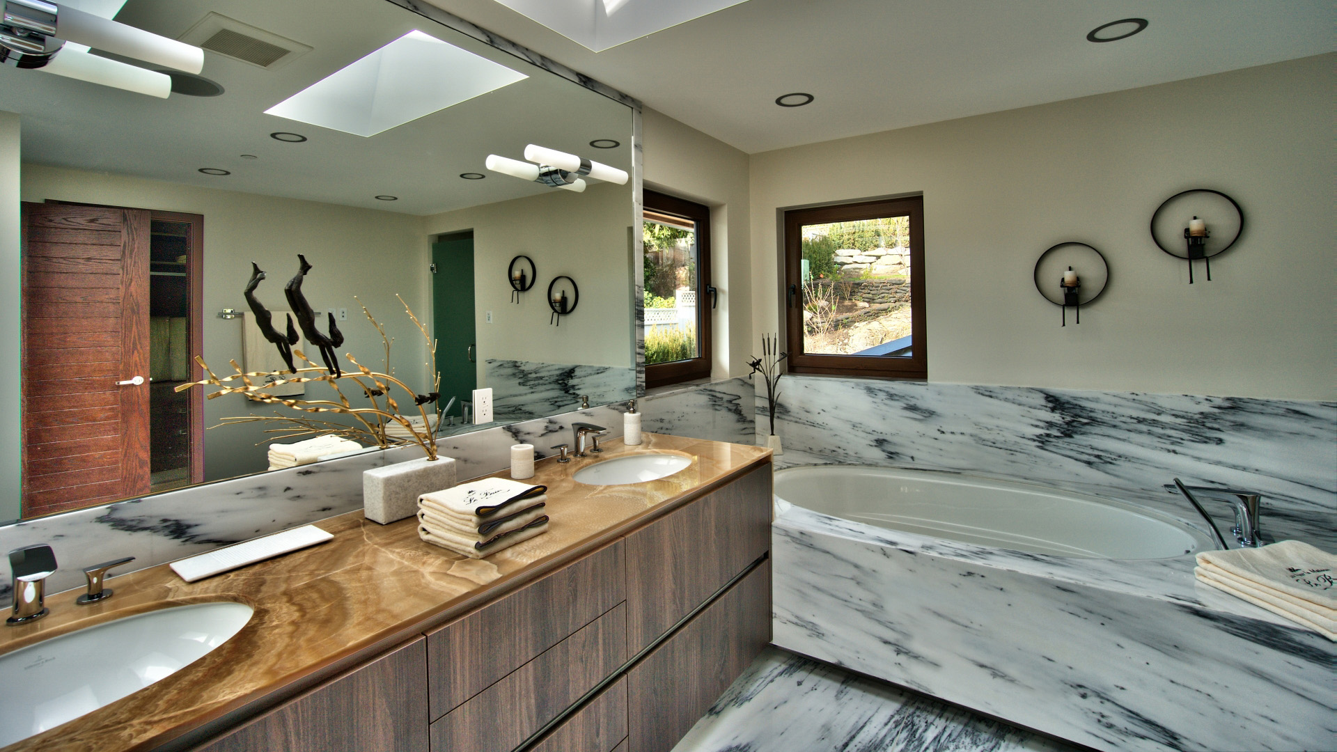Master ensuite with marble walls soaker tub onyx vanity dual sinks and walnut cabinetry luxury West Vancouver home by Eurohouse