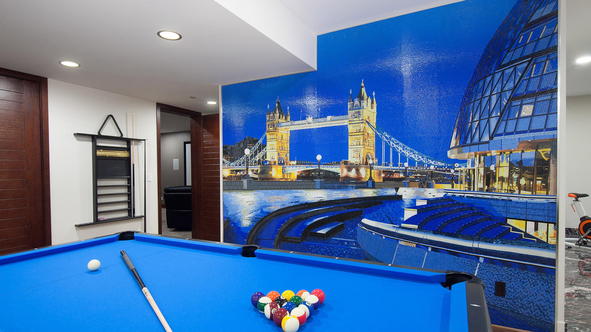 Close-up of pool table with full-wall Tower Bridge mosaic tile artwork in games room West Bay luxury home West Vancouver