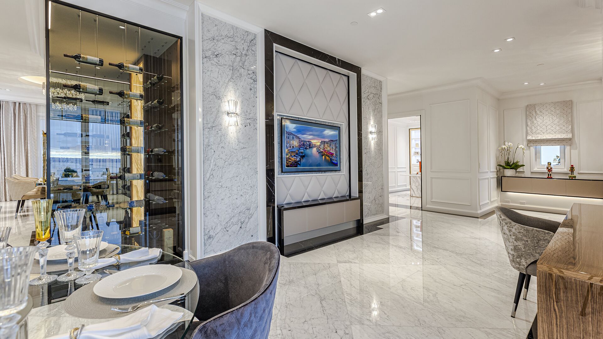 Kitchen dining area with wine display tower quilted TV surround marble walls West Vancouver luxury home by Eurohouse Construction