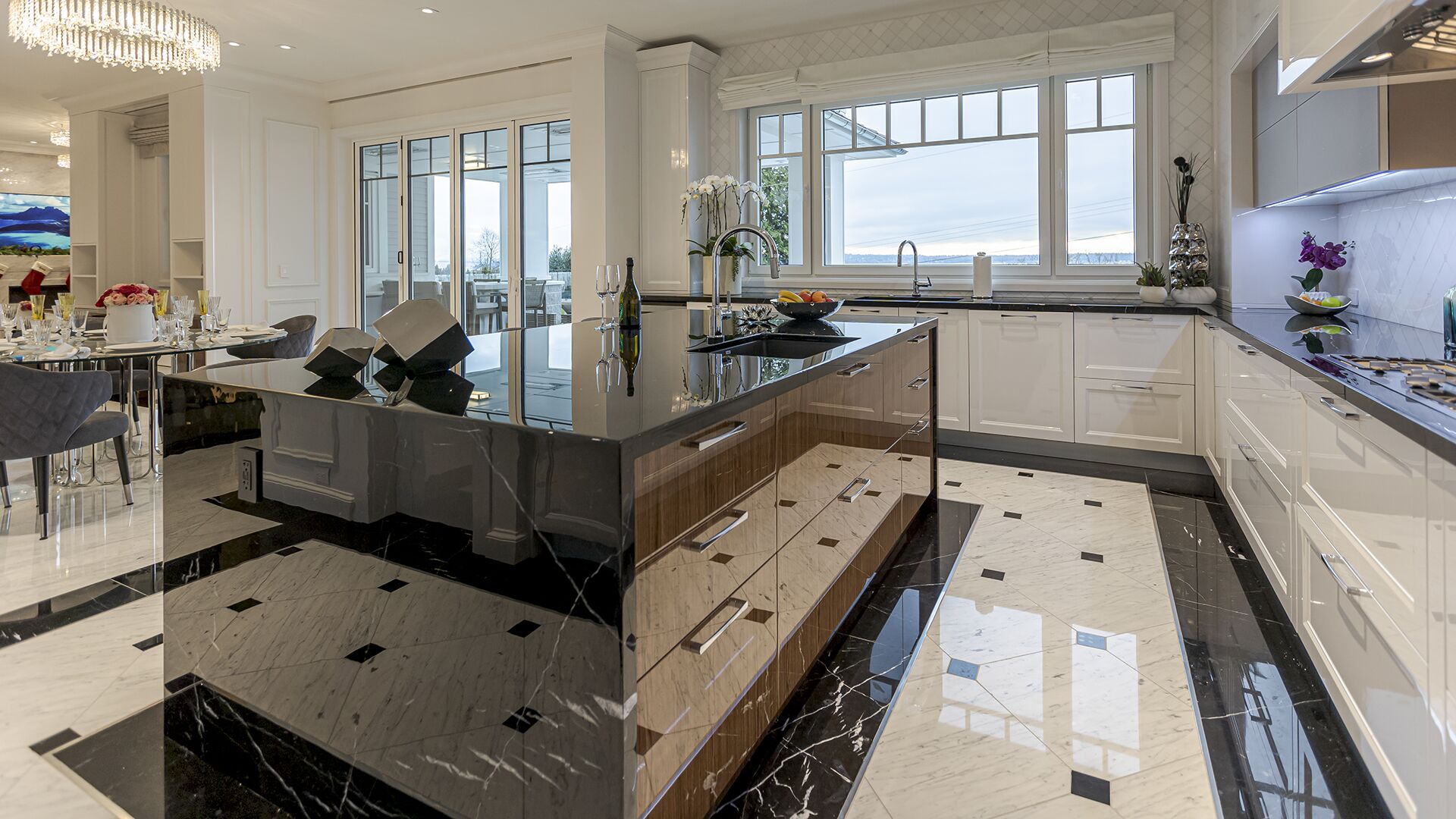 Kitchen waterfall island detail with marble floors wine display and outdoor views West Vancouver meets Manhattan Eurohouse