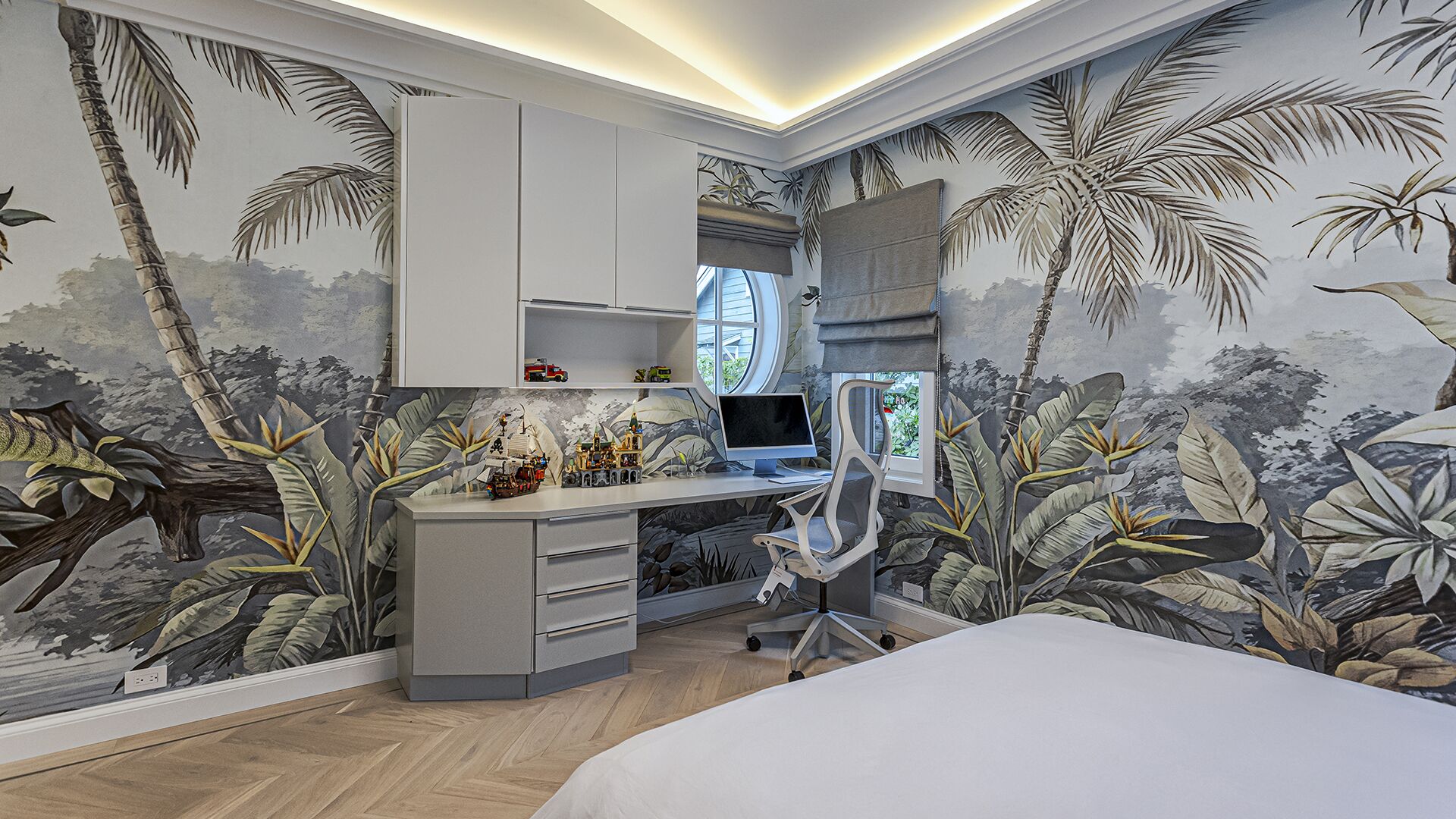 Children bedroom with tropical jungle mural built-in desk porthole window and cove lighting West Vancouver meets Manhattan Eurohouse Construction