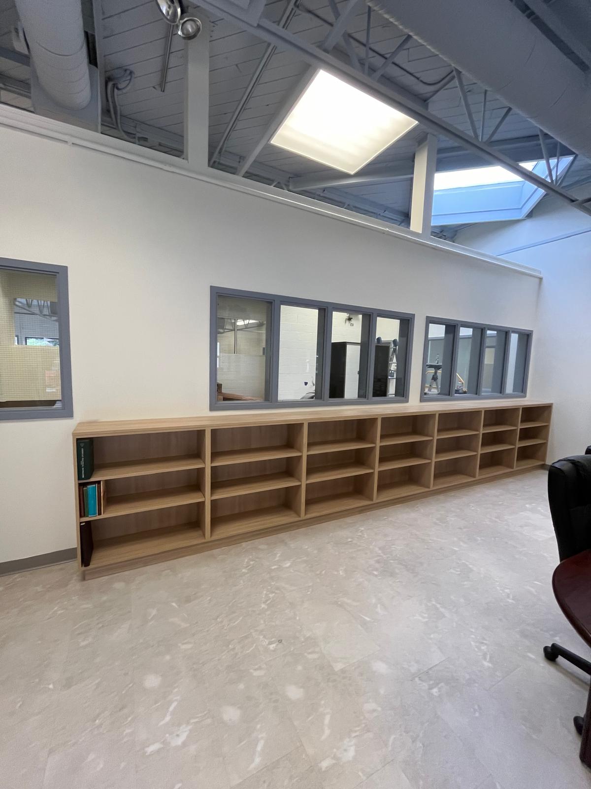 Renovated interior with new built-in shelving, partitions, skylights, and modern finishes