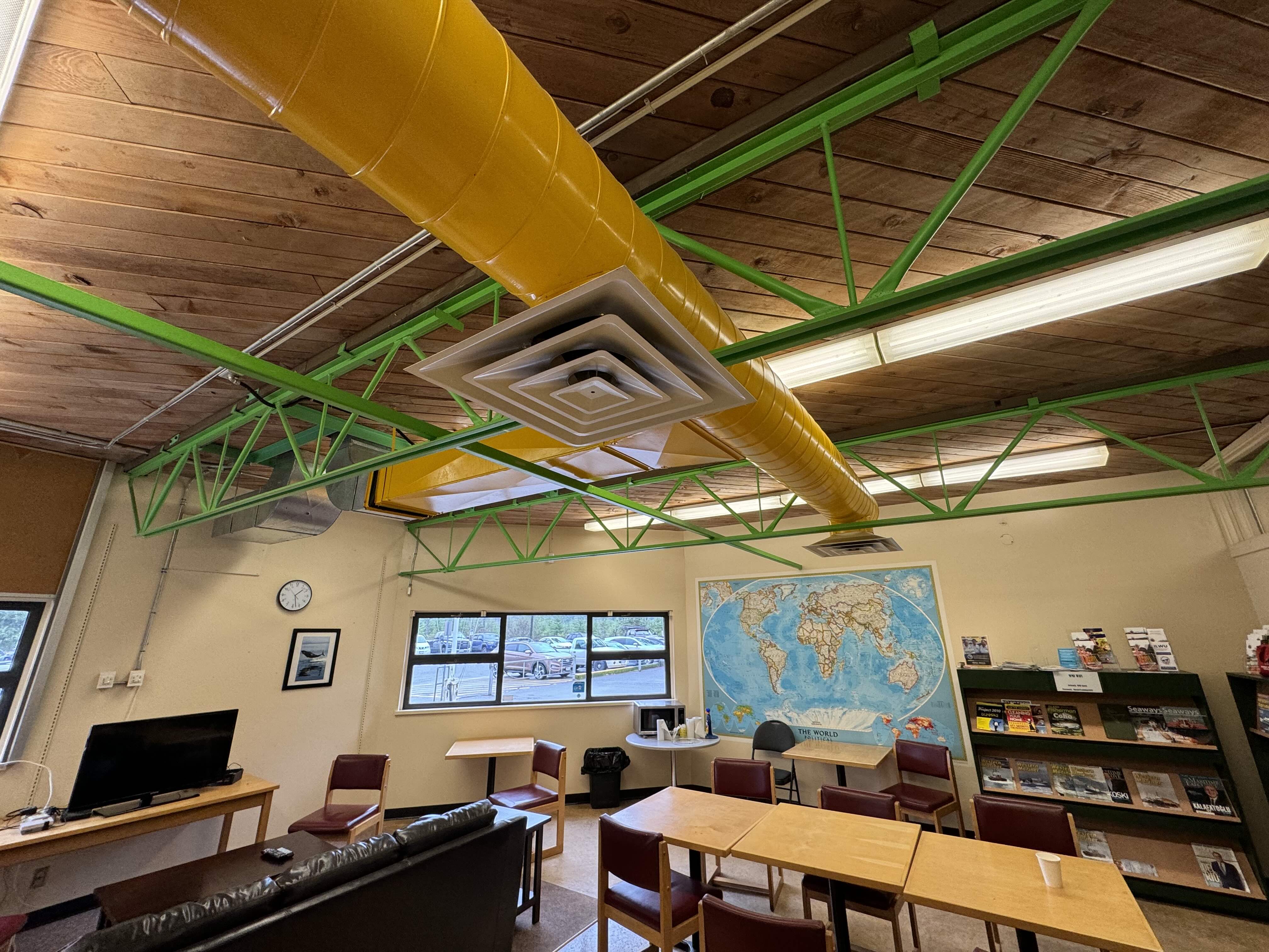 Original 1970s lounge area with exposed ductwork and dated finishes at Western Maritime Institute Ladysmith