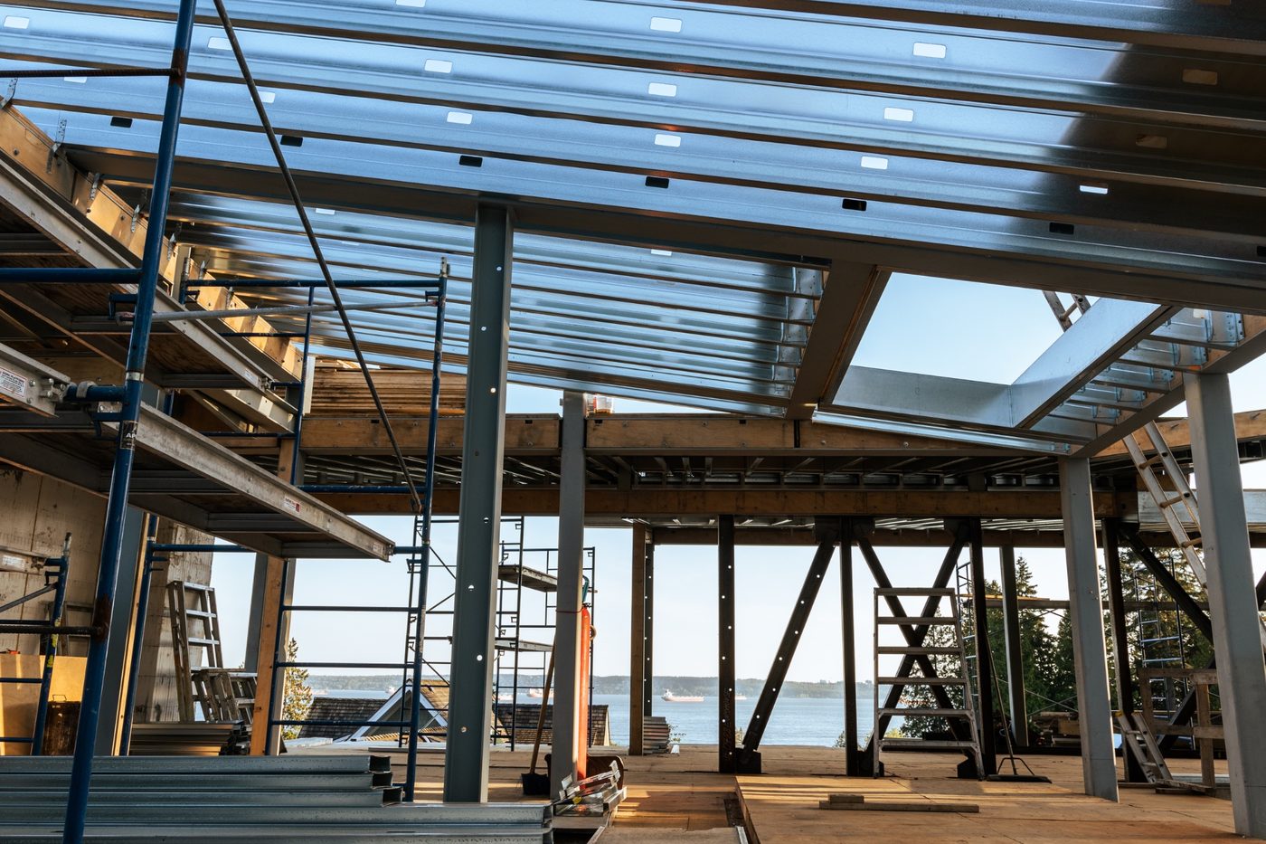 Wingline House construction — steel columns and metal deck framing with ocean views through the structure by Eurohouse Construction